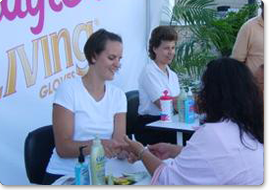 Chair massage therapists giving a hand massage during a marketing tour