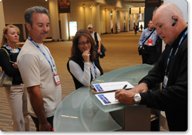 Trade show attendees sign up for a chair massage